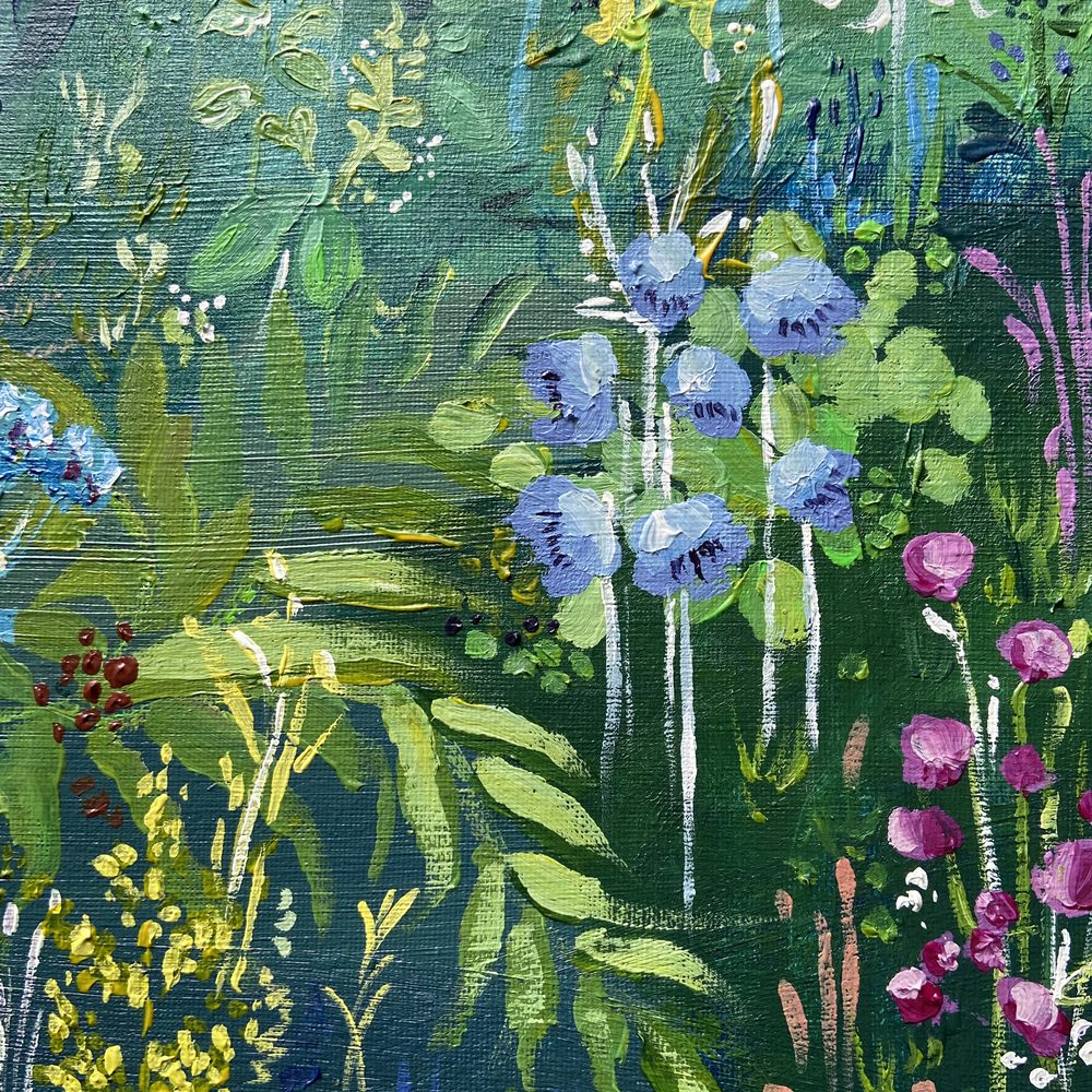 Close-up of blue bellflowers, ferns and pink blooms in The Forest of Dreams
