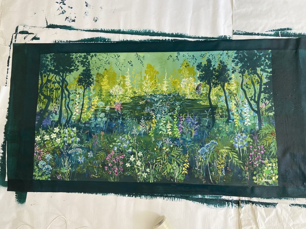 The finished painting laid flat with its edges painted dark green
