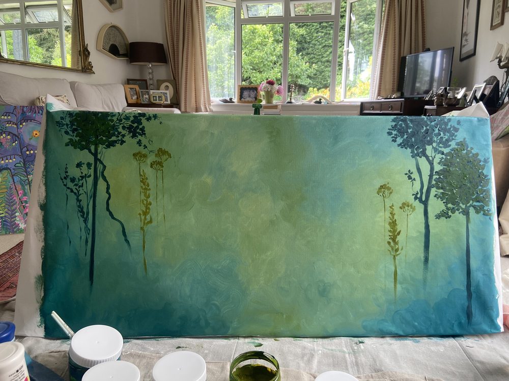 The first dark tree silhouettes painted at each side