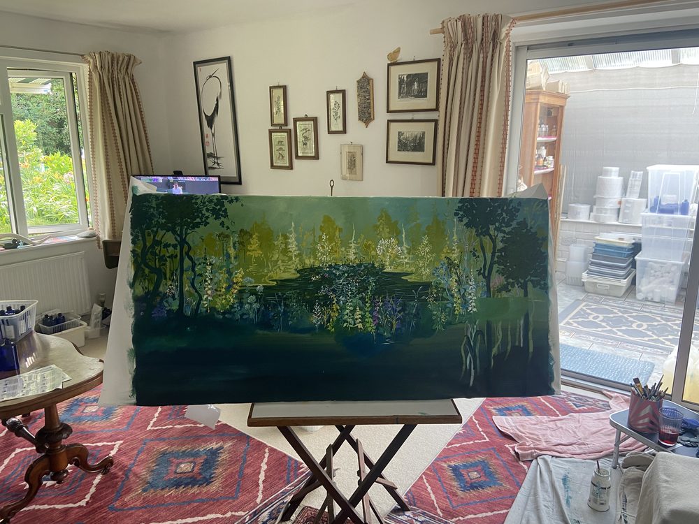 The painting on an easel with more flowers filling the forest