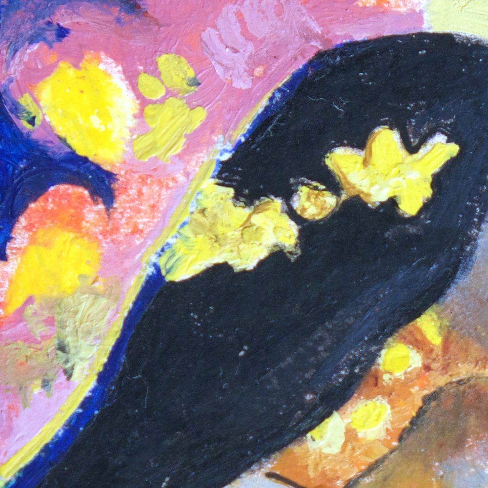 Close-up of the yellow flowers in her dark hair against pink and orange
