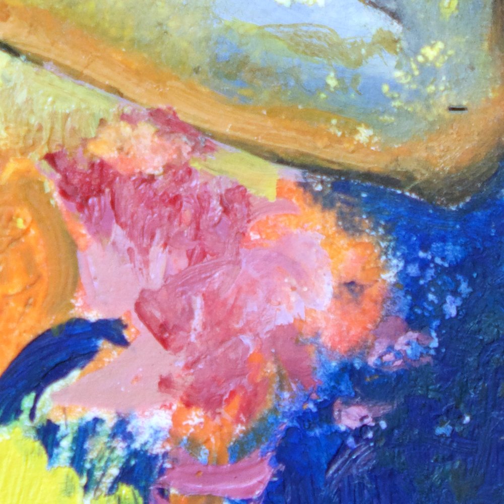 Close-up of pink flowers against deep blue below her arm