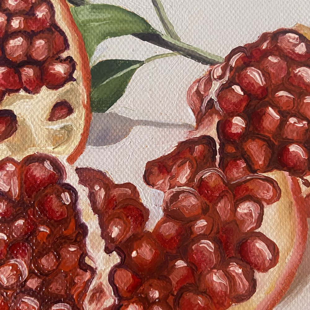 Close-up of the broken halves and their glossy red seeds